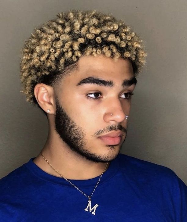 Client with a full blonde dyed curly top and low fade