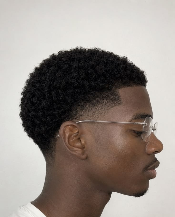Teenage client with a clean taper fade and sponge curls