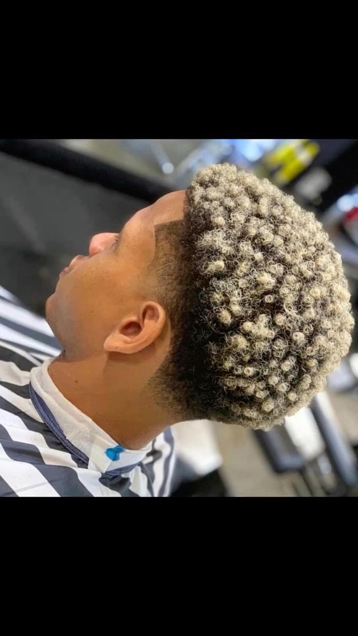 Client with blonde dyed short curls and a clean fade